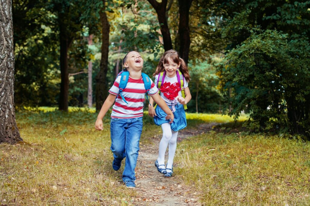 Children run with backpacks.